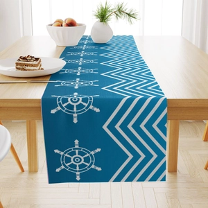 Linen table runner with navy nautical rudder and wave patterns on a wooden dining table