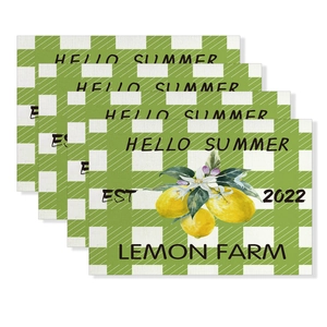 Detailed macro view of cotton linen place mats with lemon prints and green checkered pattern