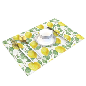 Waterproof lemon leaf print table mat with elegant gold cutlery and white ceramic cup