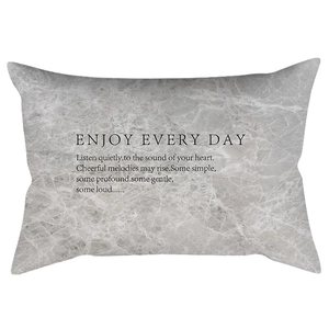 Detail of grey marble lumbar pillow cover with black Enjoy Every Day text