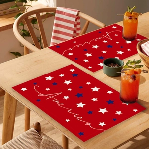 Detail of red table mat with blue and white stars and America script for festive decor