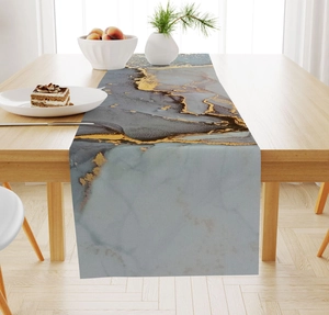Detail of marble pattern table runner with gold lines on a wooden dining table