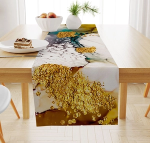 Detail of marble texture table runner with gold leaf accents on a wooden dining table