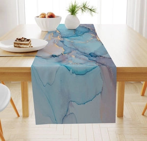 Detail view of linen table runner with blue marble pattern and golden streaks