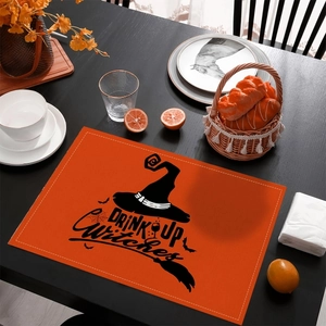 Halloween place mat with orange Drink Up Witches print on black wooden table