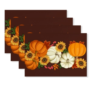 Detailed view of four waterproof placemats with festive pumpkin and sunflower print