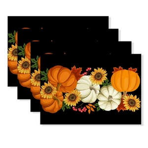 Detailed view of four stacked waterproof placemats with pumpkin and maple leaf prints
