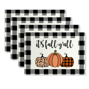 Macro detail of Thanksgiving place mats with buffalo plaid and colorful pumpkins