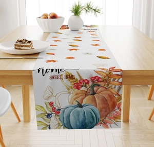 Close-up of linen table runner with autumn pumpkin prints and Home Sweet Home text