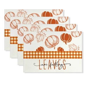 Detail of four-piece waterproof placemat set with pumpkin, maple leaf, and fall slogans