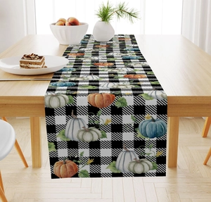 Close-up of fall pumpkin prints on black and white buffalo plaid linen table runner