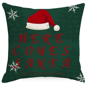 Detailed view of dark green linen Christmas pillow cover with red Santa hat and festive text