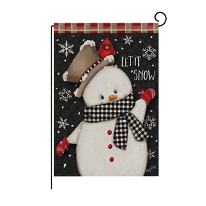 Detail of linen garden flag with snowman cardinal design and Let It Snow text