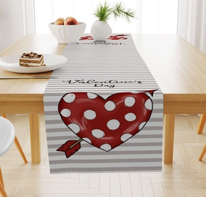 Detail of Valentine's Day table runner with red heart and arrows on linen fabric