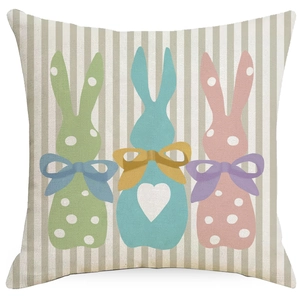 Easter linen pillowcase featuring three colorful polka dot bunnies on a striped background