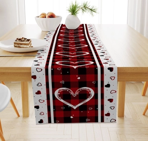 Detail of buffalo plaid table runner with red heart prints for Valentine decor