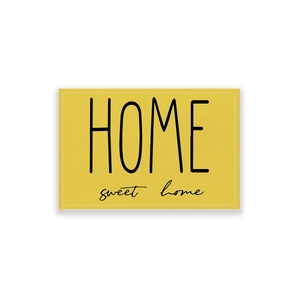 Detail of yellow cotton linen placemat with Home Sweet Home print and stitched edges