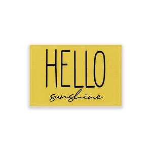 Macro detail of waterproof cotton linen placemat with HELLO sunshine print and stitching