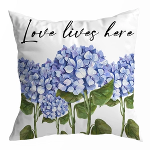 Detailed macro view of white peach skin cushion cover with blue hydrangea floral print