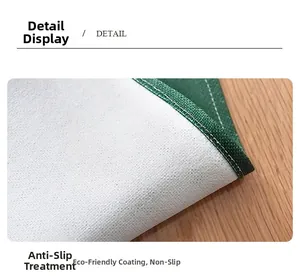 Detail of linen table runner with green stitched edges and anti-slip eco-friendly backing