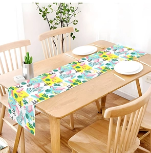 Detailed view of Flamingo and Aloha print on tropical linen table runner for home decor