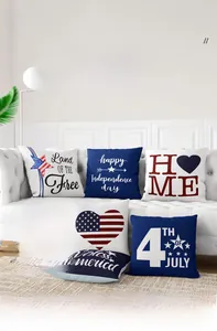 Detail of 4th of July linen pillow covers with stars and stripes on a white sofa