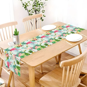 Detailed macro view of tropical flamingo and palm leaf print on durable linen table runner