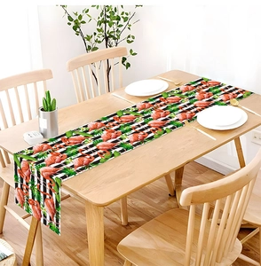 Close-up of tropical flamingo and palm leaf print table runner on wooden dining table