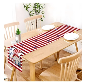 Close-up of July 4th gnome table runner with stars and stripes on wooden table