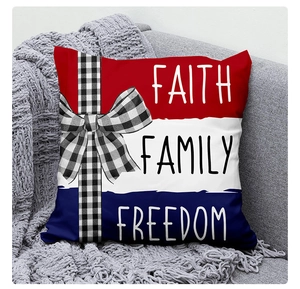 Close-up of linen pillow cover with American flag stripes, bow detail and patriotic text