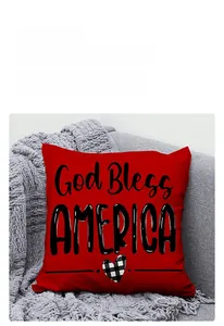 Detail of red Independence Day pillow cover featuring God Bless America text on fabric