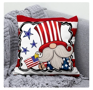 Detail of Fourth of July gnome cushion cover with American flag pattern on a gray sofa