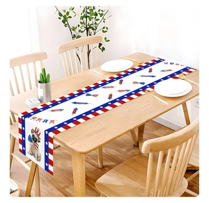 Detailed view of Fourth of July table runner with pug and fireworks on wooden table