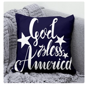 Detail view of God Bless America decorative linen pillow case on a cozy sofa setting