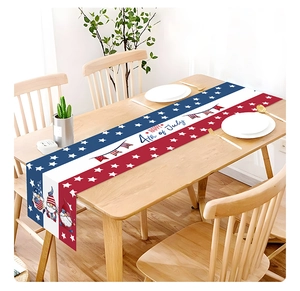 Detail view of July 4th gnome table runner with stars and stripes on wooden table
