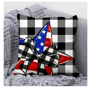Detail view of USA Independence Day buffalo plaid pillowcase on a grey fabric sofa