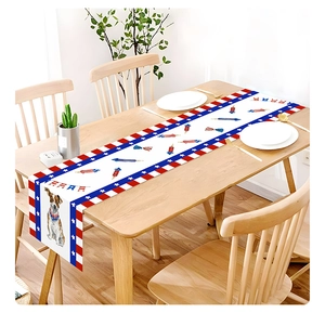 Close-up of Fourth of July table runner with patriotic fireworks and dog pattern on wood