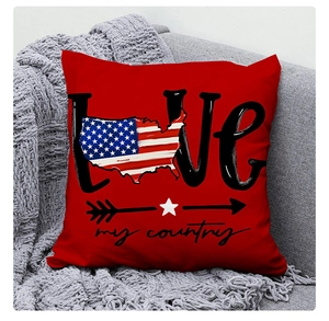 Detail of red US Independence Day linen pillowcase with patriotic LOVE print on grey sofa
