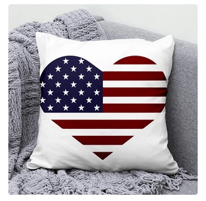 Macro shot of linen cushion cover featuring heart-shaped USA flag on a gray texture sofa