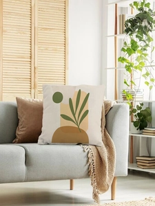 Close-up of modern abstract green leaf and geometric pattern on fabric cushion cover