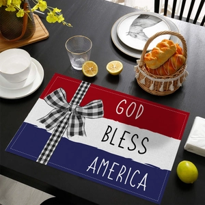 Independence Day placemat with God Bless America text on a dark wooden dining table