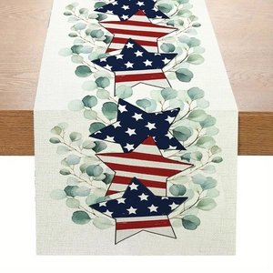Linen table runner with US flag stars and eucalyptus leaves on a wooden table