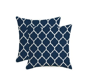 Detail of two navy blue waterproof outdoor pillow covers with white Moroccan lattice pattern