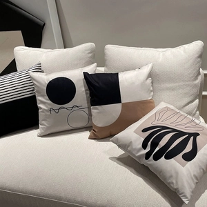 Detail showing Nordic geometric cushion covers in black and brown on a sofa set
