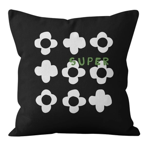 Detail of black velvet pillow cover with white floral patterns and green SUPER logo print