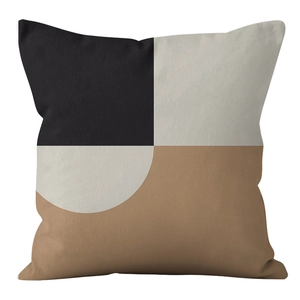 Close-up detail of geometric brown and beige patchwork fabric on Nordic pillow cover