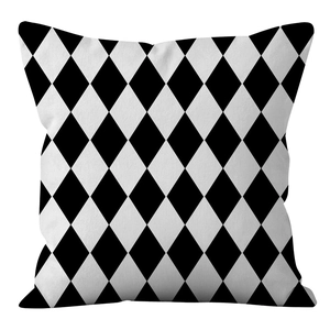 Close-up of a Nordic style cushion cover with black and white harlequin diamond pattern