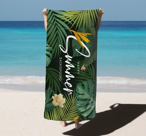 Detail of microfiber beach towel featuring tropical monstera leaves and Summer print