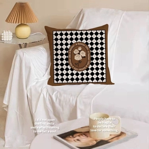 Nordic black and white checkered pillow with floral design and brown border for home decor