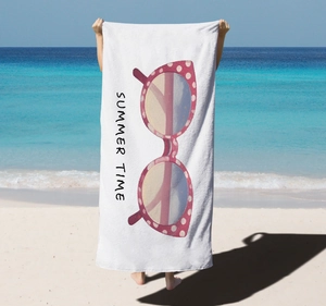 Detail of microfiber beach towel featuring pink polka dot sunglasses and Summer Time text